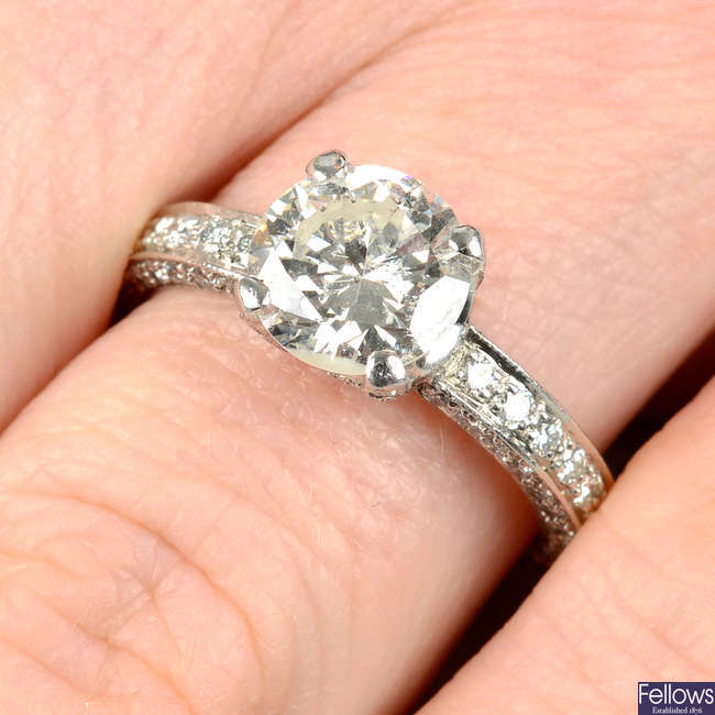 A laser-drilled brilliant-cut diamond single-stone ring, with pavé-set diamond mount.