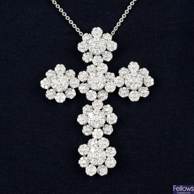 A diamond cluster cross pendant.