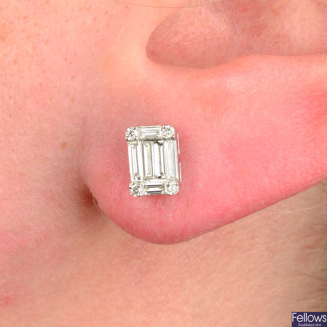 A pair of vari-cut diamond earrings.