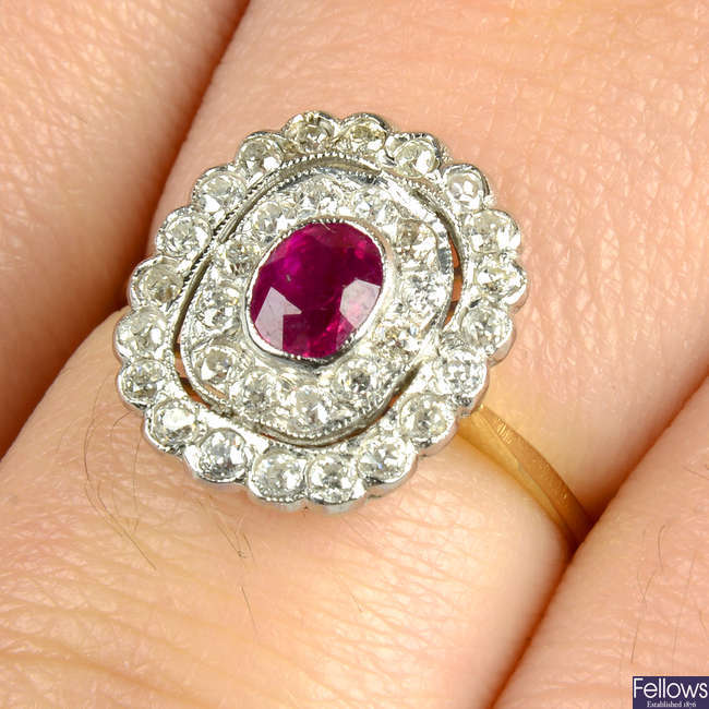 A ruby and circular-cut diamond cluster ring.