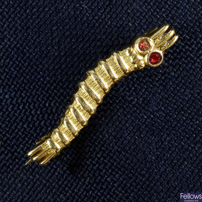 A 9ct gold red enamel 'Caterpillar Club' badge, engraved 'Sgt. W. H. T. Farmer'.