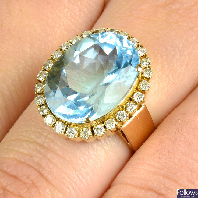 A blue topaz and brilliant-cut diamond dress ring.
