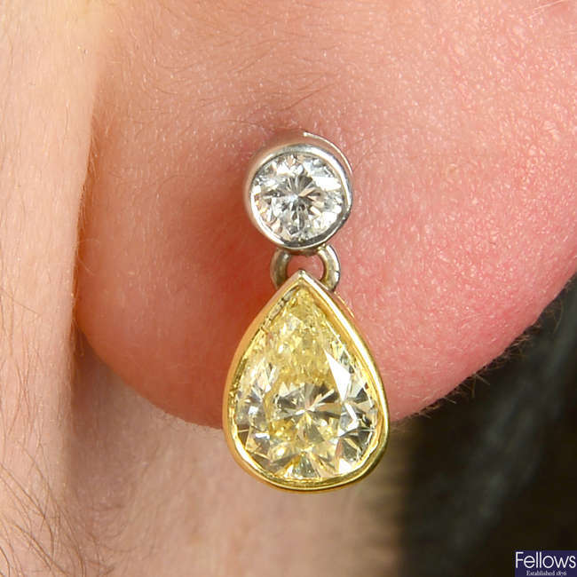 A pair of bi-colour 18ct gold pear-shape 'light yellow' diamond earrings, with brilliant-cut diamond stud surmount.