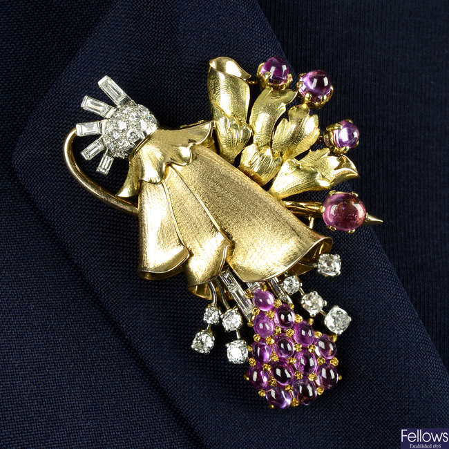 A 1940s tri-colour 18ct gold pink sapphire, pink tourmaline and vari-cut diamond floral spray brooch.
