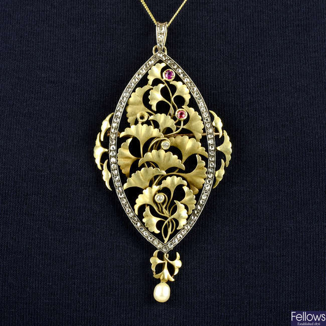 An Art Nouveau silver and gold, vari-cut diamond, ruby and cultured pearl ginkgo leaf pendant/brooch.