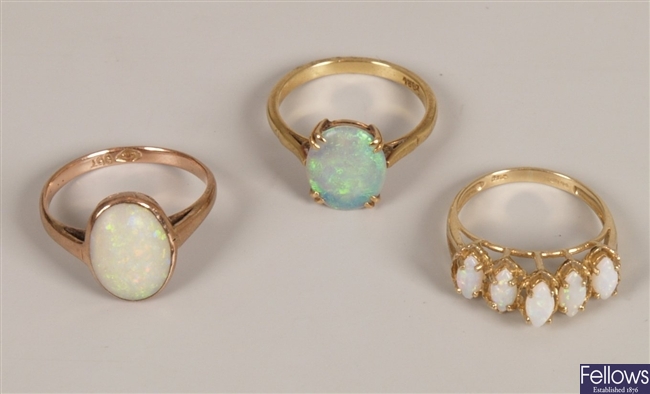 Three opal set rings, to include a 9ct gold five