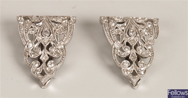 A pair of diamond clip brooches of triangular