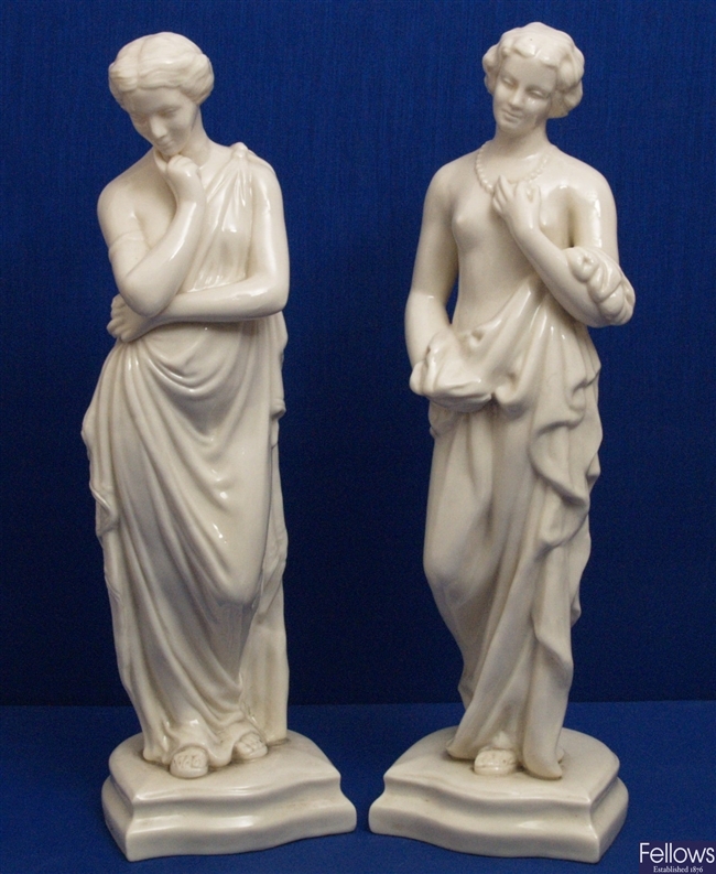 A pair of Belleek glazed parion figures,