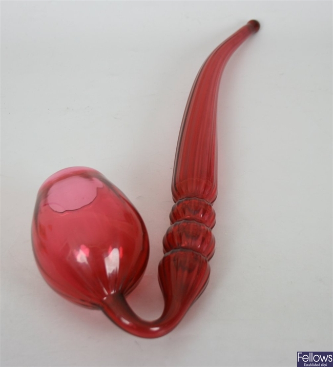 A Victorian cranberry glass pipe, with three