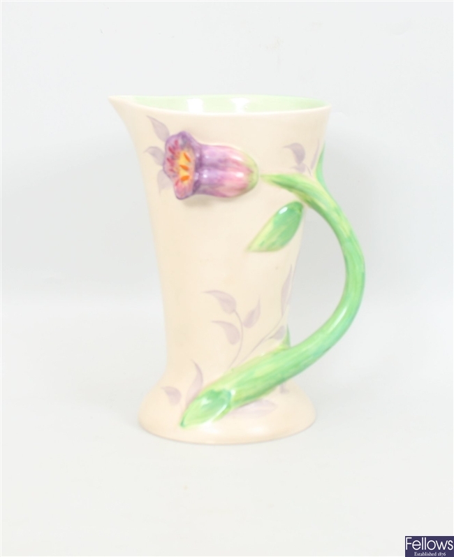 A Clarice Cliff jug, the handle modelled as a