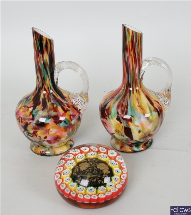 A pair of multi coloured glass jugs with clear
