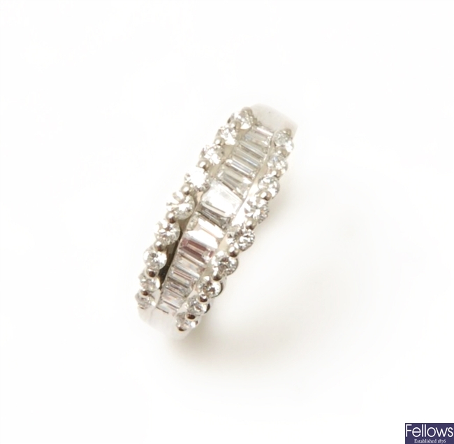 An 18ct white gold diamond band ring, with a