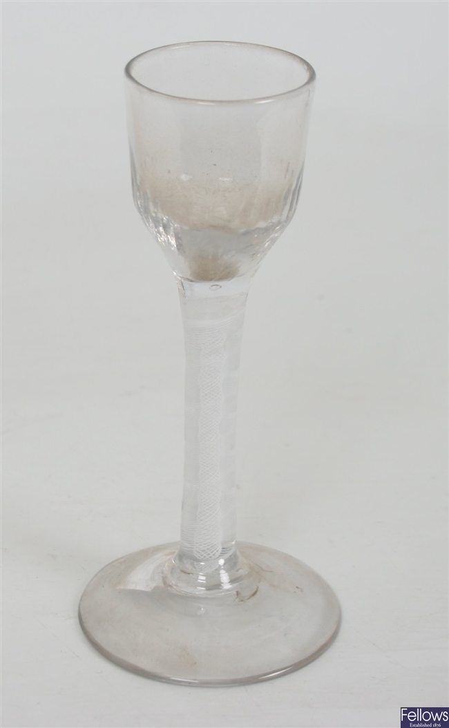 An antique wine glass with rounded fluted bowl on