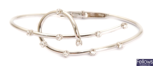 An 18ct white gold diamond set curved design