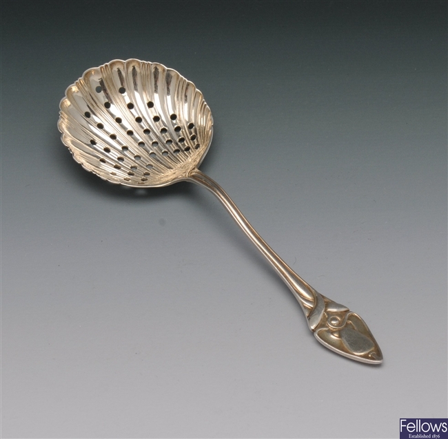 An Arts Nouveau silver sifter spoon with pierced
