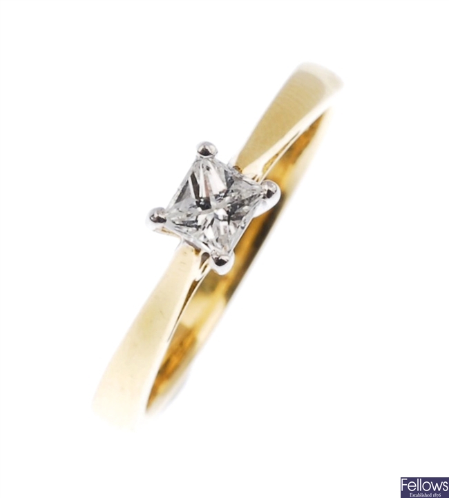 A bi-colour single stone diamond ring.