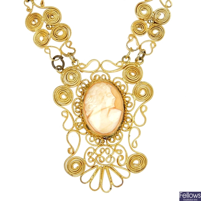 A filigree cameo necklace and a cheroot holder.