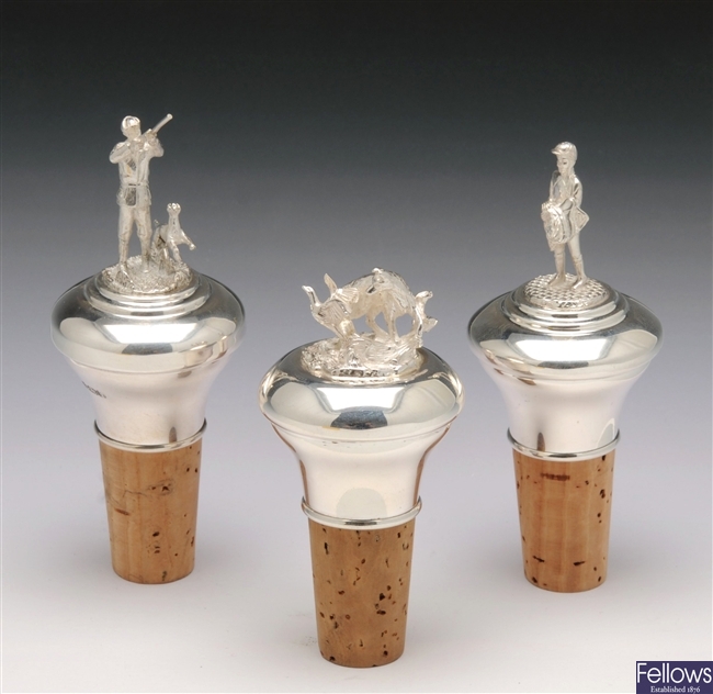 Two hunting and one jockey silver mounted bottle stoppers