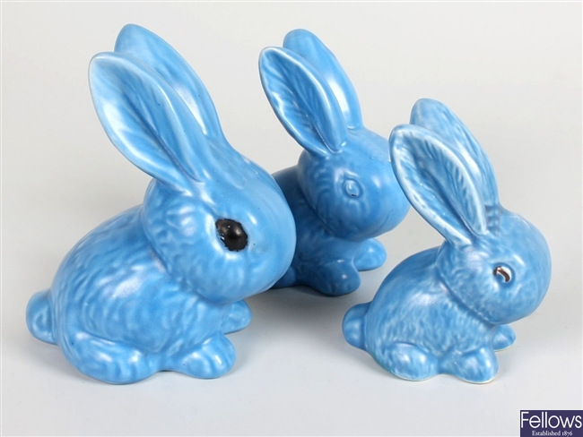 Three Sylvac blue glazed snub nosed pottery rabbits, a Beleek small pot and a figurine