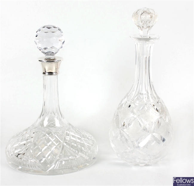 A cut glass ships decanter and stopper and other decanters
