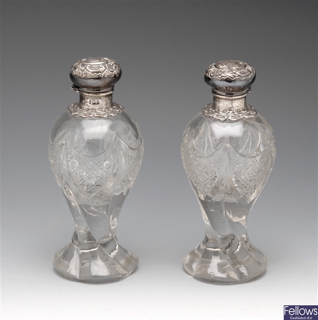 Pair of Edwardian silver mounted glass vanity bottles.