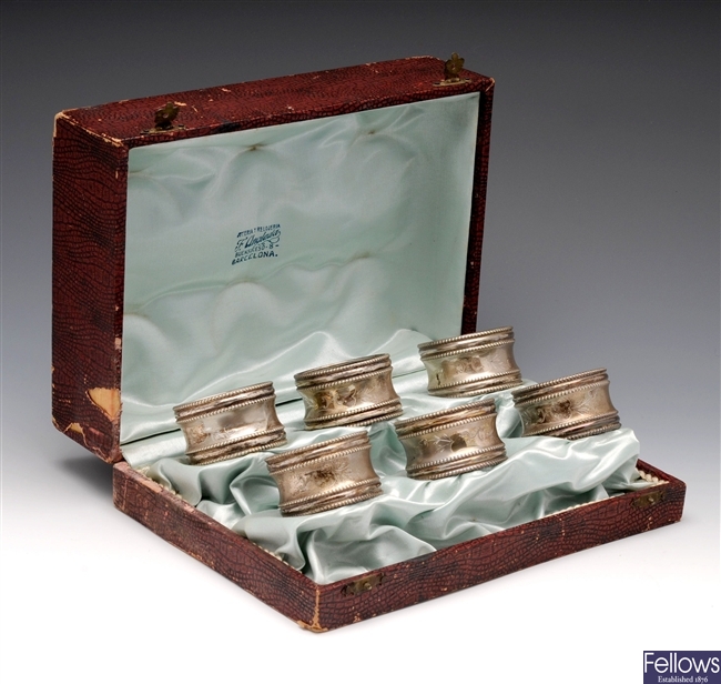 Cased set of six continental white metal napkin rings.
