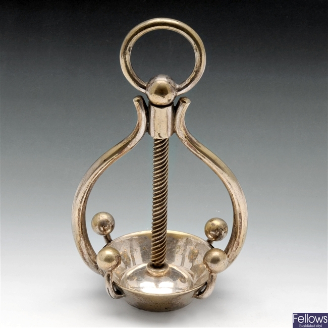 A silver plated lemon squeezer.