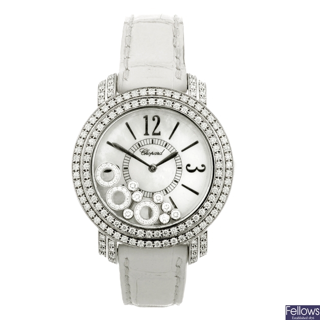 An 18k white gold quartz Chopard Happy Diamond wrist watch.