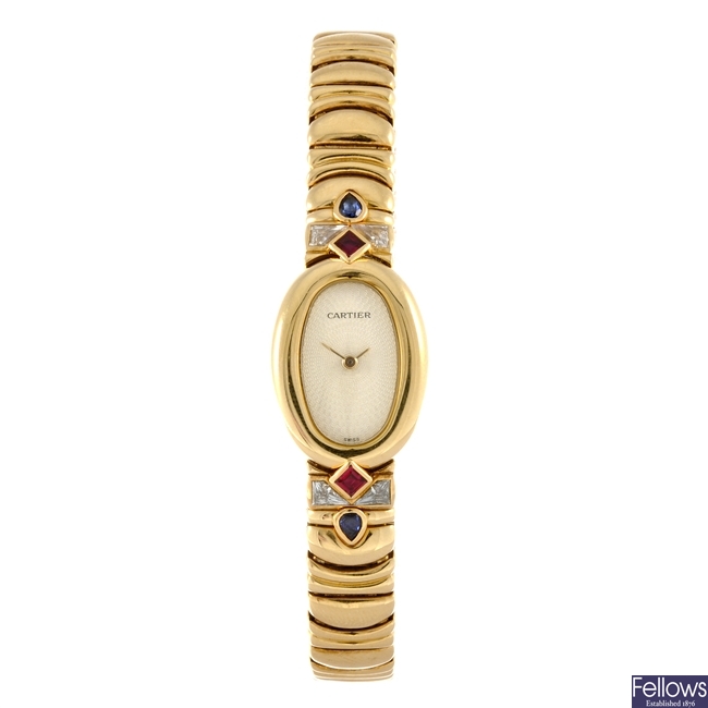 An 18k gold quartz lady's Cartier Baignoire bracelet watch.