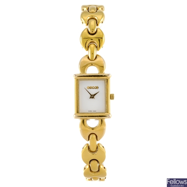 LOT:27 | A gold plated quartz lady's Gucci 1800L bracelet watch.