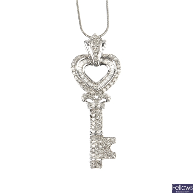 A 9ct gold diamond key pendant.