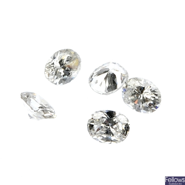 A quantity of loose oval-shape diamonds.