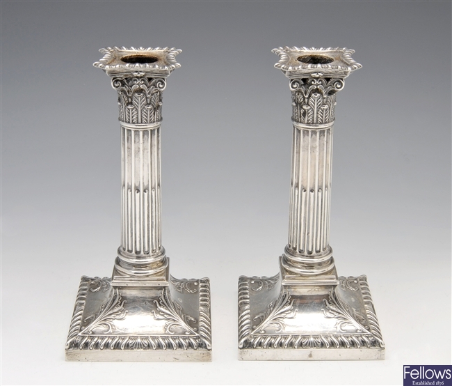 Late Victorian silver mounted pair of candlesticks.