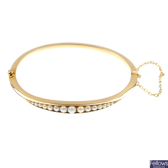 A late 19th century 15ct gold split pearl bangle.