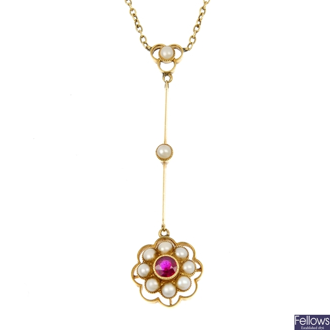 An early 20th century gold ruby and split pearl pendant.