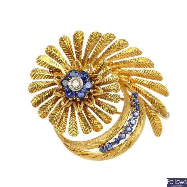 A continental sapphire and diamond flower brooch.