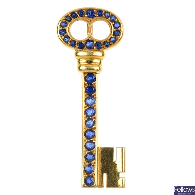 CARTIER - an 18ct gold sapphire key pendant.