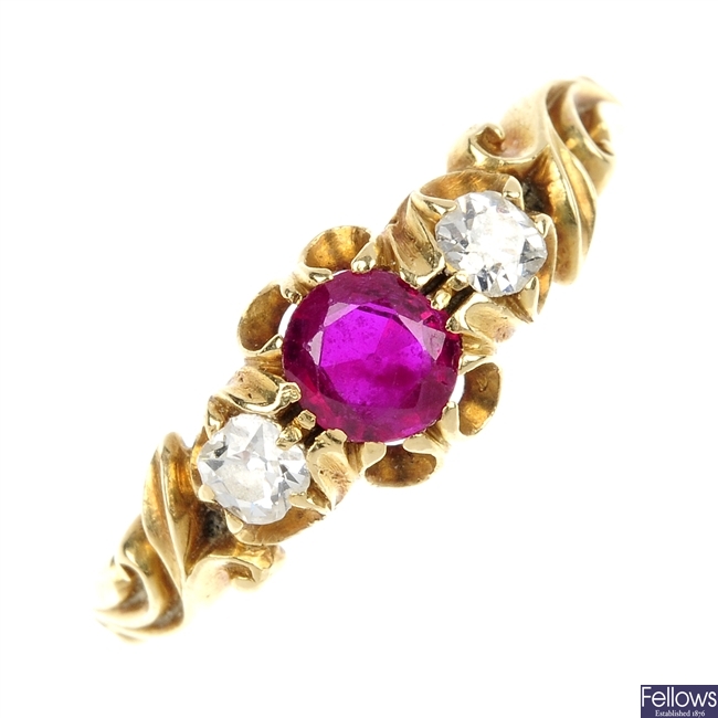 A late 19th century gold ruby and diamond three-stone ring.