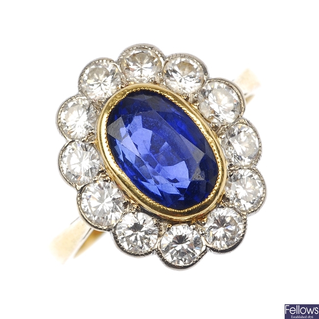 (528324-1-A) An 18ct gold sapphire and diamond cluster ring.