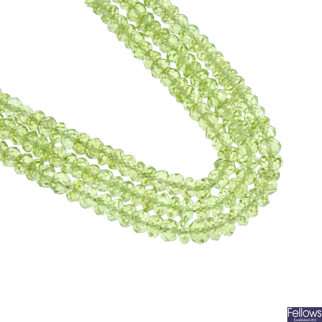 Three strands of faceted peridot beads. 