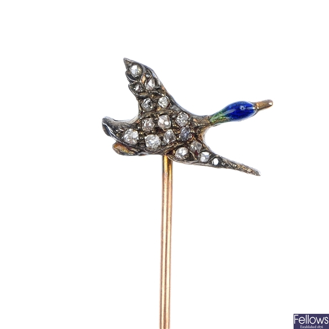A golf stick pin and a diamond and enamel duck stick pin.