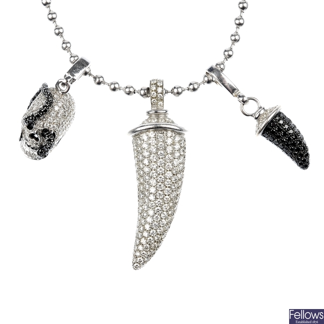 THEO FENNELL - an 18ct gold diamond and black diamond charm necklace.