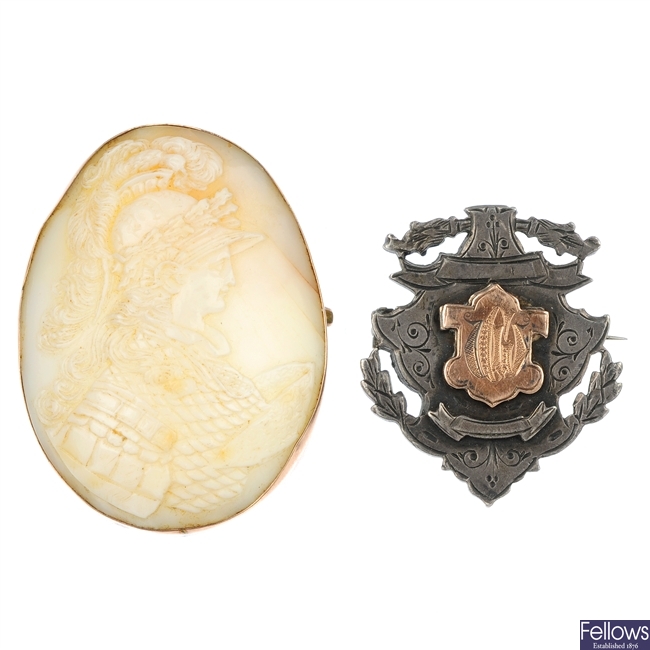A shell cameo brooch and a silver medallion brooch.