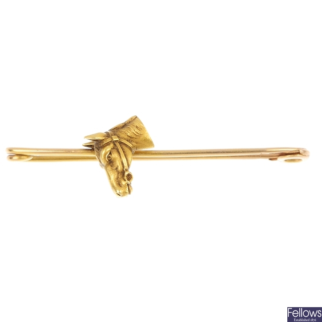 A French 18ct gold horse's head bar brooch.