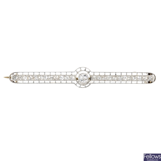 An early 20th century 9ct gold and platinum diamond bar brooch.