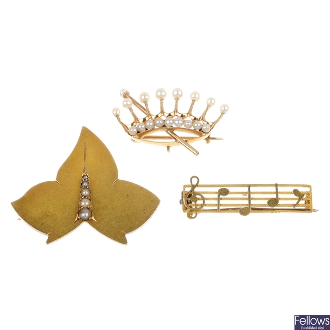 An assortment of four late 19th century and later gold brooches.