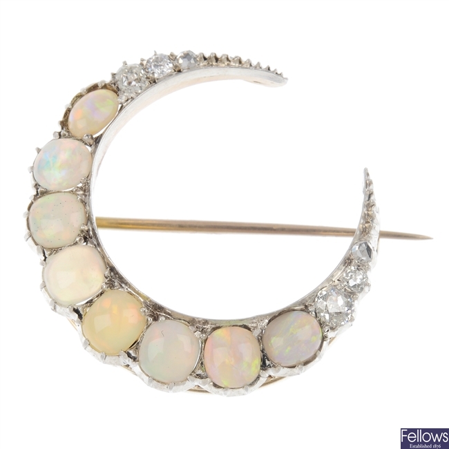 An opal and diamond crescent brooch.