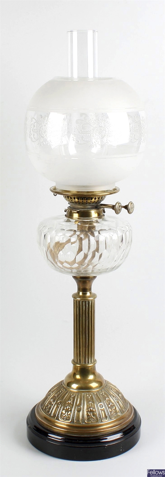 19th century oil lamp with glass reservoir lamp shade and chimney.