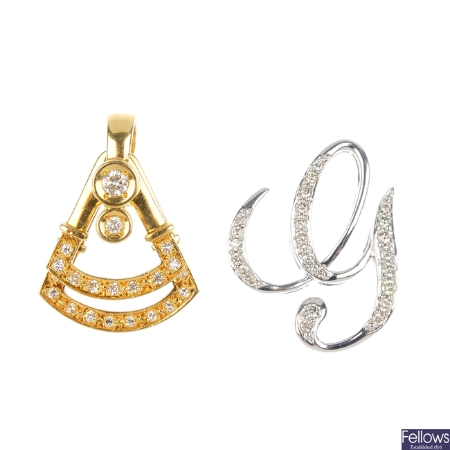 Two diamond pendants.