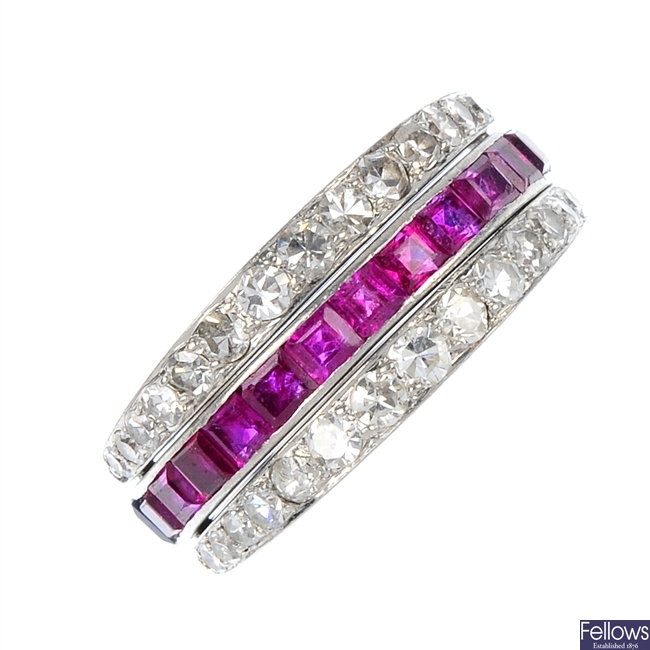 A mid 20th century platinum diamond, ruby and sapphire three-row ring.